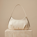 Izzy & Ali (cream) hobo style bag with crossbody strap.